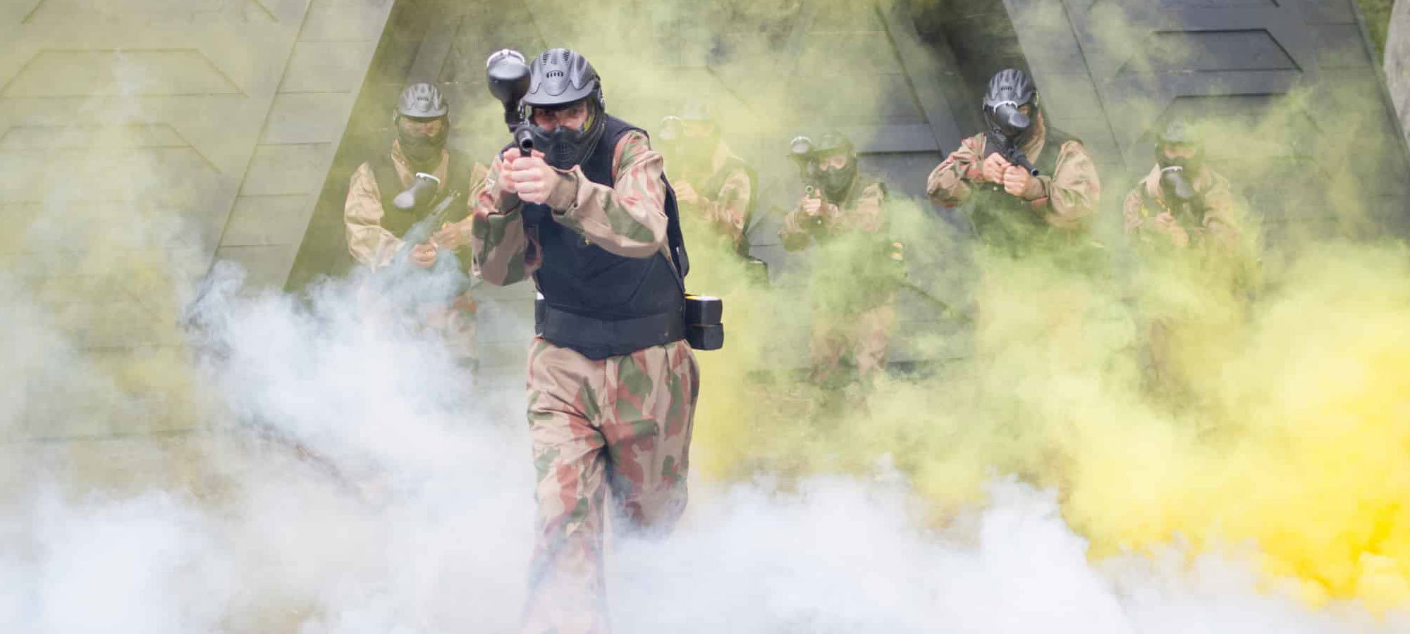 Players advancing through a paintball game zone